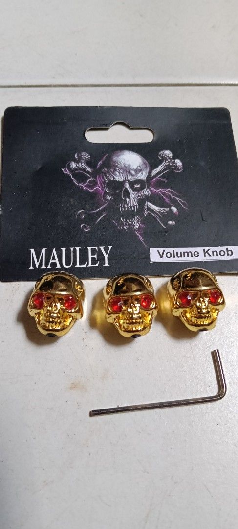Mauley Skull Volume Knobs (Category: Music Accessories) located in Singapore. Submitted by oldandslowlearner (Listing ID 1423106598, Image 2). Description: Set of three skull-shaped volume knobs by Mauley. Available in silver and gold finishes, both with red eyes. Includes an Allen key for installation. Brand new and sealed. Self collect in Bukit Gombak..