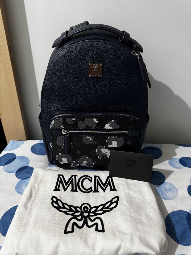 MCM Stark Backpack (Category: Luxury Bags & Wallets) located in Pasay City. Submitted by mydeer08 (Listing ID 1423240715, Image 1). Description: - Authentic MCM Stark backpack - Navy blue color - Unique front pocket design - Multiple zippered compartments - Adjustable straps - Includes dust bag and authenticity card - MCM logo and serial number on interior tag - Top handle for easy carrying - 100% Authentic -can pass as brand new .