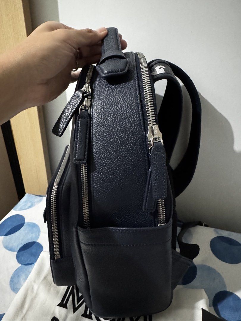 MCM Stark Backpack (Category: Luxury Bags & Wallets) located in Pasay City. Submitted by mydeer08 (Listing ID 1423240715, Image 2). Description: - Authentic MCM Stark backpack - Navy blue color - Unique front pocket design - Multiple zippered compartments - Adjustable straps - Includes dust bag and authenticity card - MCM logo and serial number on interior tag - Top handle for easy carrying - 100% Authentic -can pass as brand new .