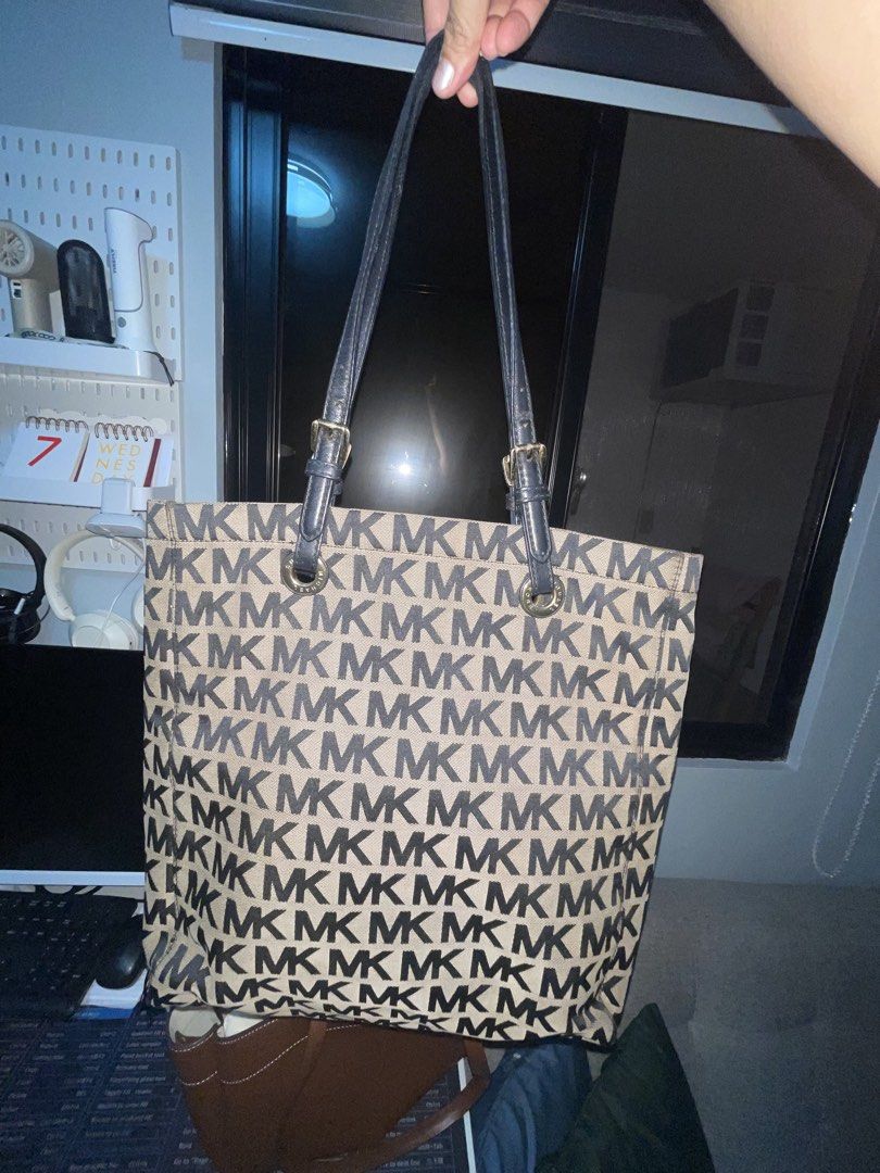Michael Kors MK Tote Bag (Category: Luxury Bags & Wallets) located in Manila. Submitted by dnash29 (Listing ID 1423176844, Image 2). Description: - Authentic Michael Kors tote bag - Features the iconic MK logo print (black and beige) - Black leather handles - Gold-tone hardware - Black fabric interior - Includes a small pocket with Michael Kors label - Spacious design, ideal for daily use -40cm height -32cm length -5c width .