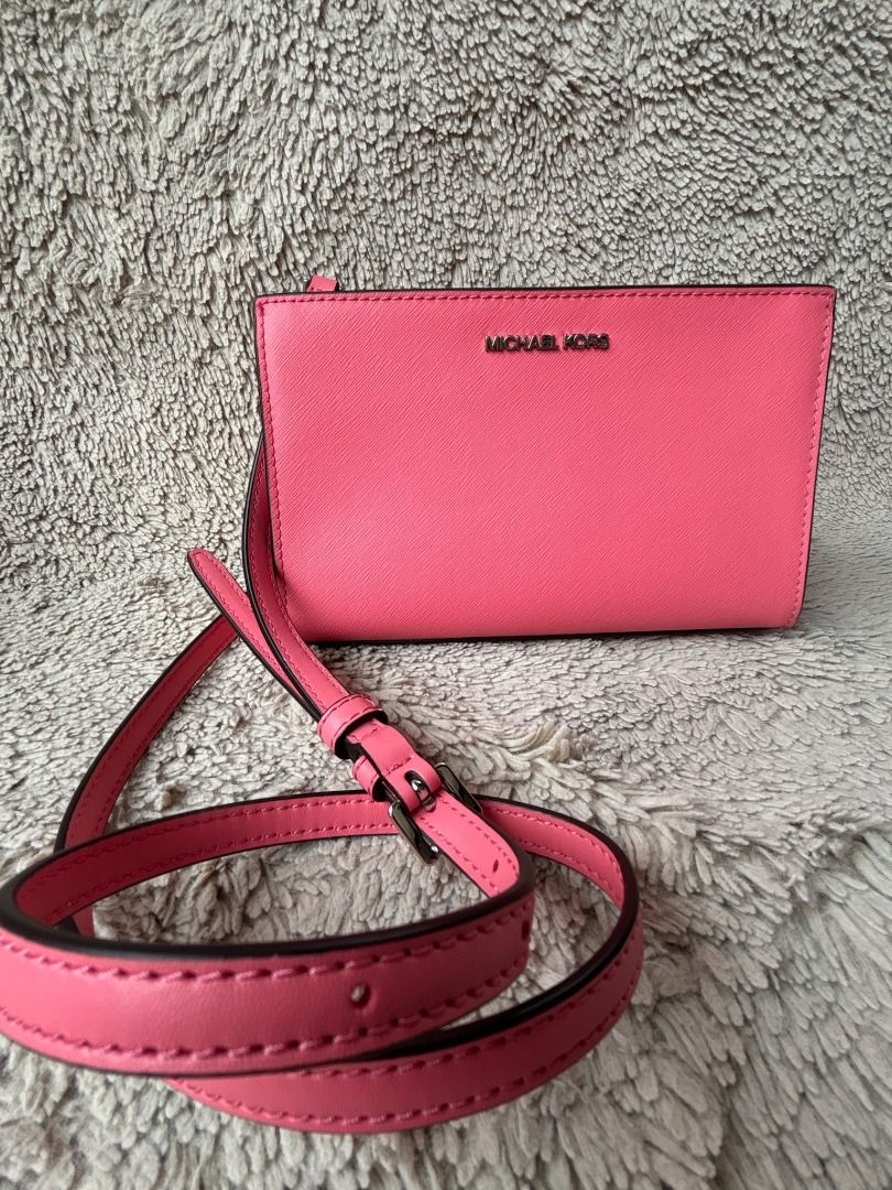 Authentic Michael Kors Pink Crossbody Bag (Category: Luxury Bags & Wallets) located in Caloocan City. Submitted by ginger-feet (Listing ID 1423088878, Image 1). Description: Authentic! M•K• Michael Kors Sheila Saffiano Small Pink Crossbody Bag Size: 8” x 5” x 2.5” Good condition, very pretty Trendy small bag Pre-loved, Japan sourced No box, no dustbag.