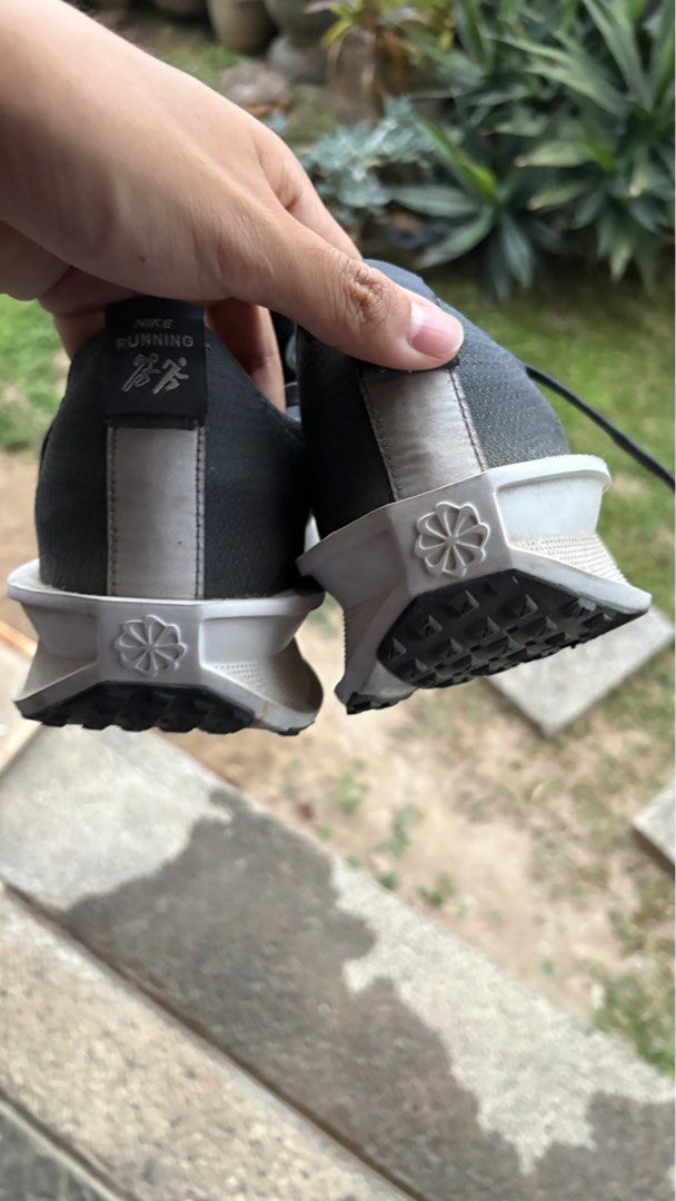 Nike Interact Run (Category: Sneakers) located in Orion. Submitted by reddotitems (Listing ID 1423174506, Image 3). Description: USED FOR 147km, hence the rugged outsole. Bought on January 16 for Bataan grand run for 2699 - Dark grey upper with white midsole - Visible Nike logo - Shows wear on soles - Laced design - Breathable construction - Unique tread pattern for grip.
