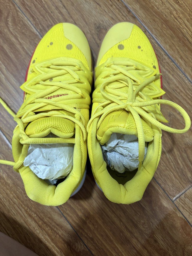 Nike Kyrie 5 SpongeBob Sneakers (Category: Sneakers) located in Muntinlupa City. Submitted by xiannahailey (Listing ID 1423159699, Image 2). Description: - Nike Kyrie 5 'SpongeBob' edition - Vibrant yellow colorway - SpongeBob SquarePants detailing - Red toe accent - White midsole - Nike logo visible - SpongeBob graphics on insoles - Size: US 7.5, UK 6, EUR 38.5, 24.5 CM.