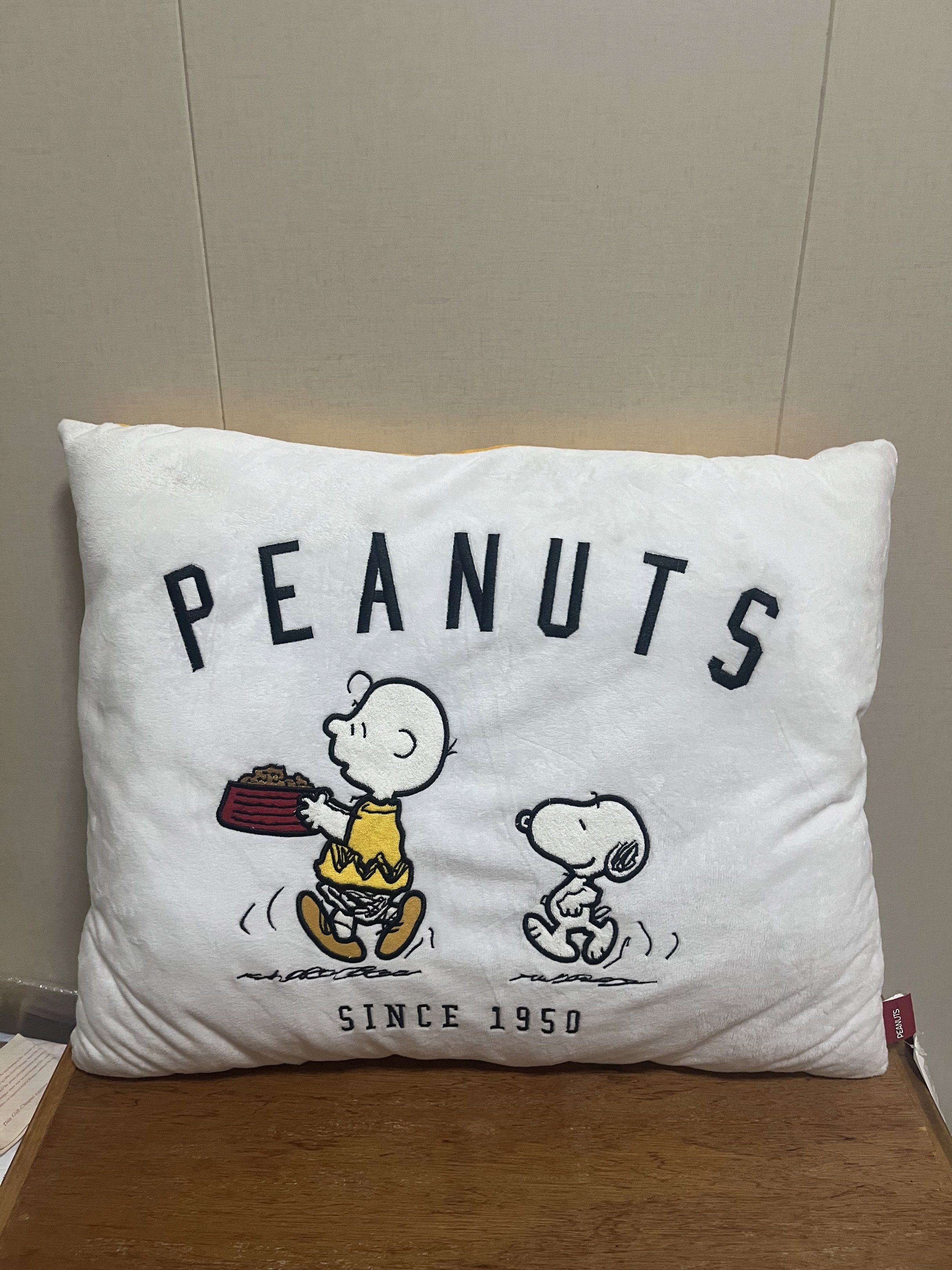 Peanuts Snoopy Pillow (Category: Plushies & Soft Toys) located in Las Pinas. Submitted by stuffhaven (Listing ID 1423107969, Image 2). Description: Location : Las Piñas Pick up or lalamove. -Pillow features Snoopy and Charlie Brown -One side has a yellow background with "Snoopy" printed on it. The other side has a white background with "Peanuts Since 1950" printed on it. -The pillow has a tag attached. -There is a small stain/dirt on the white si