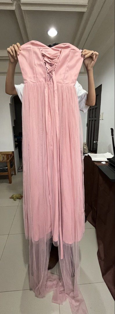Pink Corset Style Infinity Bridesmaid Dress (Category: Dresses) located in Manila. Submitted by emericerv (Listing ID 1423143321, Image 3). Description: Elegant pink bridesmaid dress. Features a sweetheart neckline and a corset back for an adjustable fit. The dress has a pleated bodice and a flowing tulle skirt. Includes a small bow detail at the waist. Perfect for weddings or formal events. Measurements: 32A Waist: 26in Height: 5'3 1/2 RFS: will