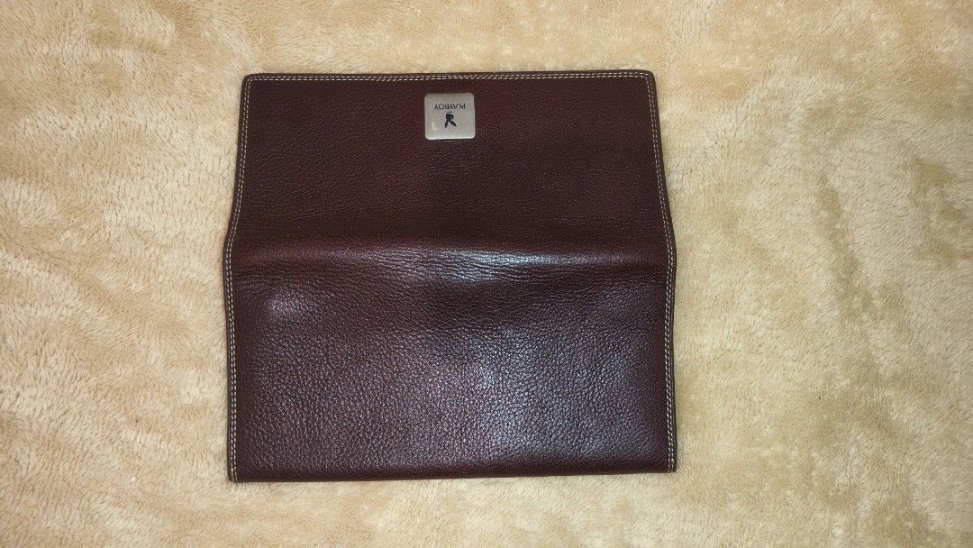 Playboy Brown Leather Wallet (Category: Wallets & Card holders) located in Tanza. Submitted by declutterolshoppe (Listing ID 1423168183, Image 3). Description: - Playboy brown leather wallet - Multiple card slots - Compartments for bills and essentials - Snap closure - Playboy logo on front and inside - Visible stitching - Classic and functional design.