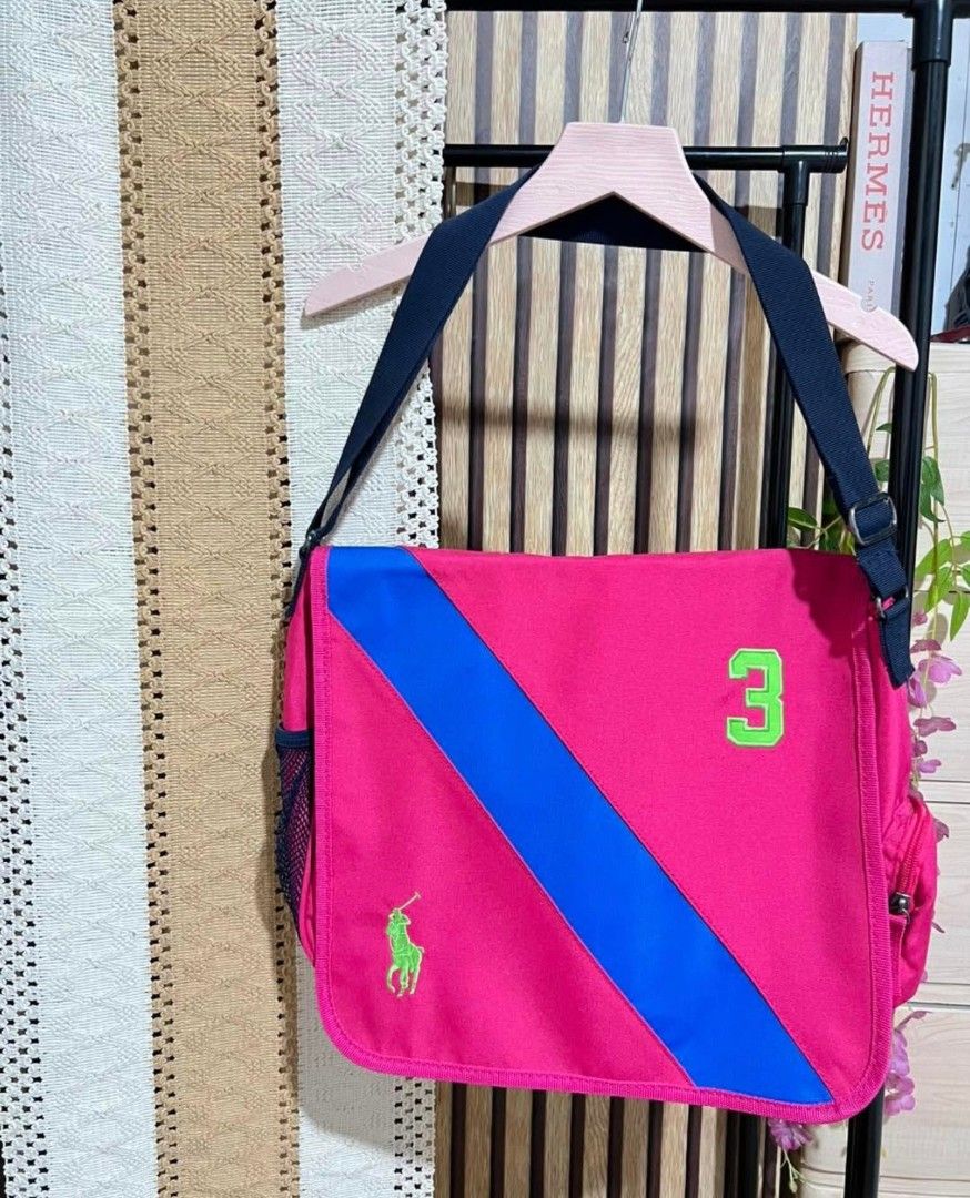 Ralph Lauren Messenger Bag (Category: Luxury Bags & Wallets) located in Caloocan City. Submitted by bestdealsonline99 (Listing ID 1423231274, Image 1). Description: POLO RALPH LAUREN BANNER STRIPE MESSENGER BAG // price slightly negotiable Width 16 inch / Length 13 inch Bagong bago to , super Ganda - Polo Ralph Lauren messenger bag - Eye-catching pink color with blue stripe and number 3 - Green Polo logo - Navy blue strap - Multiple compartments 