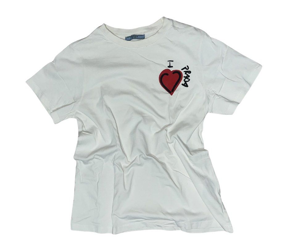 Prada Shirt Valentine Special Edition (Category: Luxury Apparel) located in Tarlac. Submitted by riki_b (Listing ID 1423239345, Image 1). Description: Prada Ivory Red Hearts Valentine Special Edition ↳ ₱ 1,350+ sf (nego) Small on tag Length: 22.5 Width: 17 Overall Condition: 9/10 see photo, what you see is what you get DM ME FOR NEGOTIATIONS & INQUIRIES.