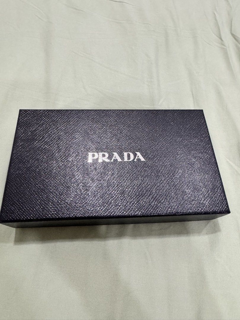 Prada Vitello Move Leather Wallet (Category: Luxury Bags & Wallets) located in Quezon City. Submitted by declutteringrobb (Listing ID 1423203336, Image 3). Description: - Authentic Prada wallet - Black Vitello Move leather - Gold-tone Prada logo - Detachable card holder included - Multiple compartments and zippered pocket - Comes with original box, authenticity and cards - Leather and fabric interior - Stored and never used - RFS: wrong size, too