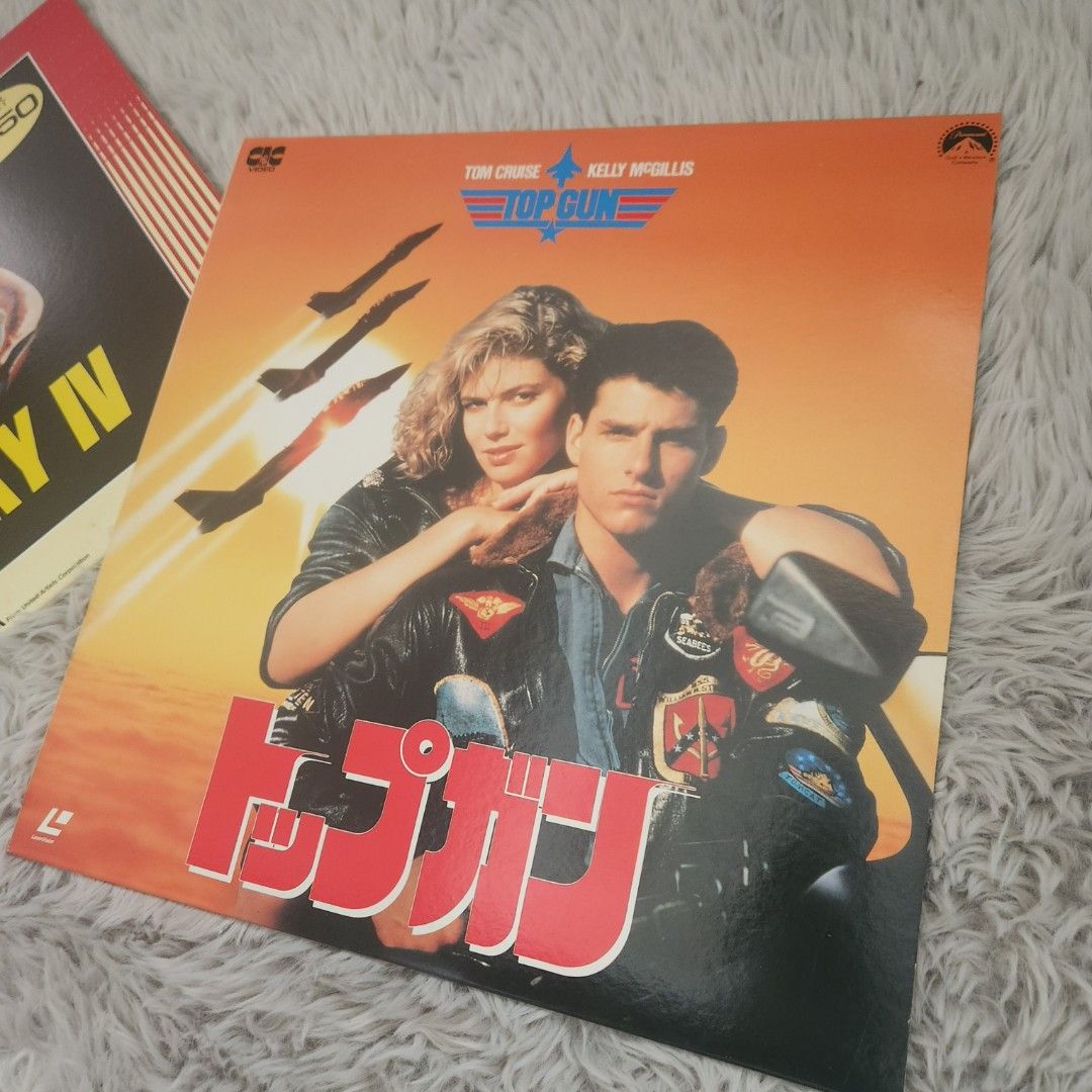 Rocky IV & Top Gun Laserdiscs (Category: CDs & DVDs) located in Manila. Submitted by racz03 (Listing ID 1423083852, Image 2). Description: - Two laserdiscs for sale: "Rocky IV" and "Top Gun". - "Rocky IV" has a price tag of ¥4,950. - Both discs are in their original packaging. - "Top Gun" features Tom Cruise and Kelly McGillis. Both In Nearmint to Mint Condition, No Scratches. price is For Both Item.