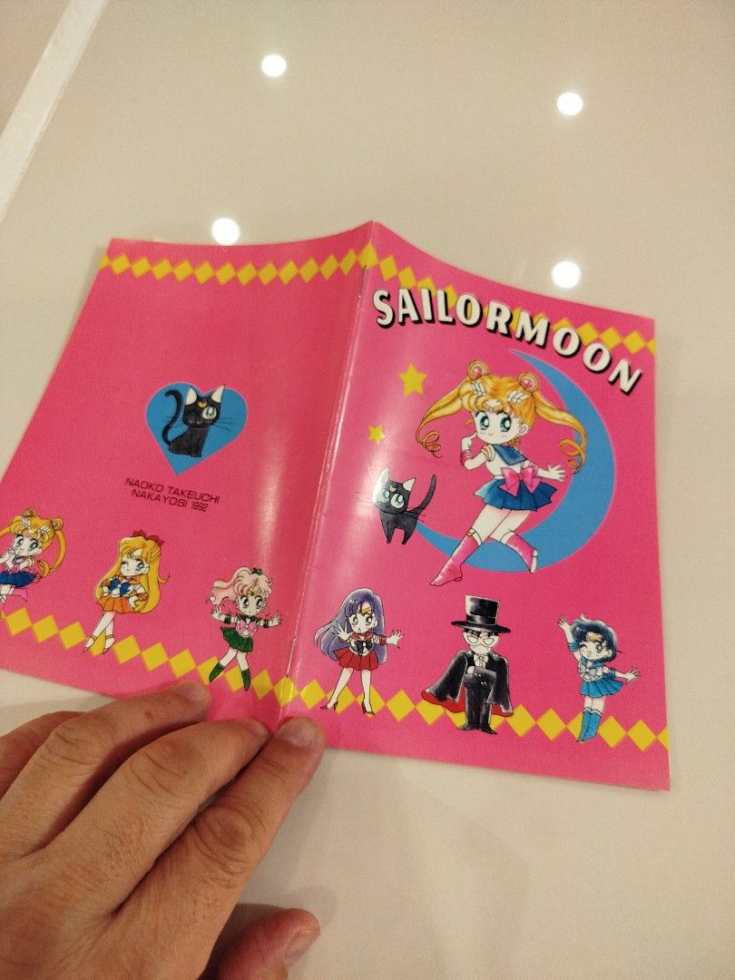 Sailor Moon Notebook (Category: Stationery & School Supplies) located in Caloocan City. Submitted by toys_r_here (Listing ID 1423201523, Image 2). Description: - Vintage Sailor Moon notebook - Features Sailor Moon and other characters - Pink cover with Sailor Moon graphics - Lined pages - Sailor Moon character illustrations at the bottom of pages - From the 90s.
