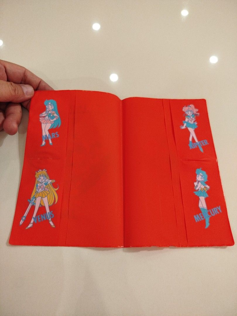 Sailor Moon Official Fanbook 1993 (Category: Comics & Manga) located in Caloocan City. Submitted by toys_r_here (Listing ID 1423201201, Image 2). Description: - Sailor Moon Official Fanbook from 1993 - Includes: - Yellow Fanbook (Sailor Moon and characters on cover) - Red Booklet (Sailor Moon characters on cover and inside) - Contains character data and illustrations.