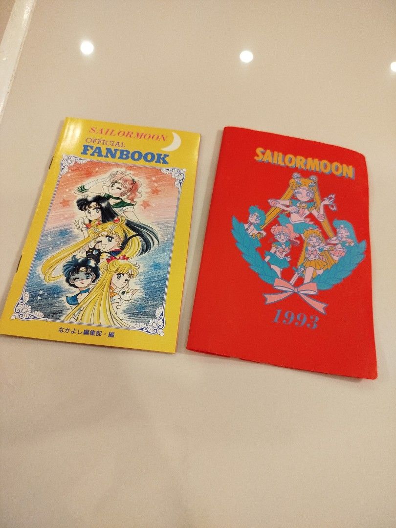 Sailor Moon Official Fanbook 1993 (Category: Comics & Manga) located in Caloocan City. Submitted by toys_r_here (Listing ID 1423201201, Image 1). Description: - Sailor Moon Official Fanbook from 1993 - Includes: - Yellow Fanbook (Sailor Moon and characters on cover) - Red Booklet (Sailor Moon characters on cover and inside) - Contains character data and illustrations.