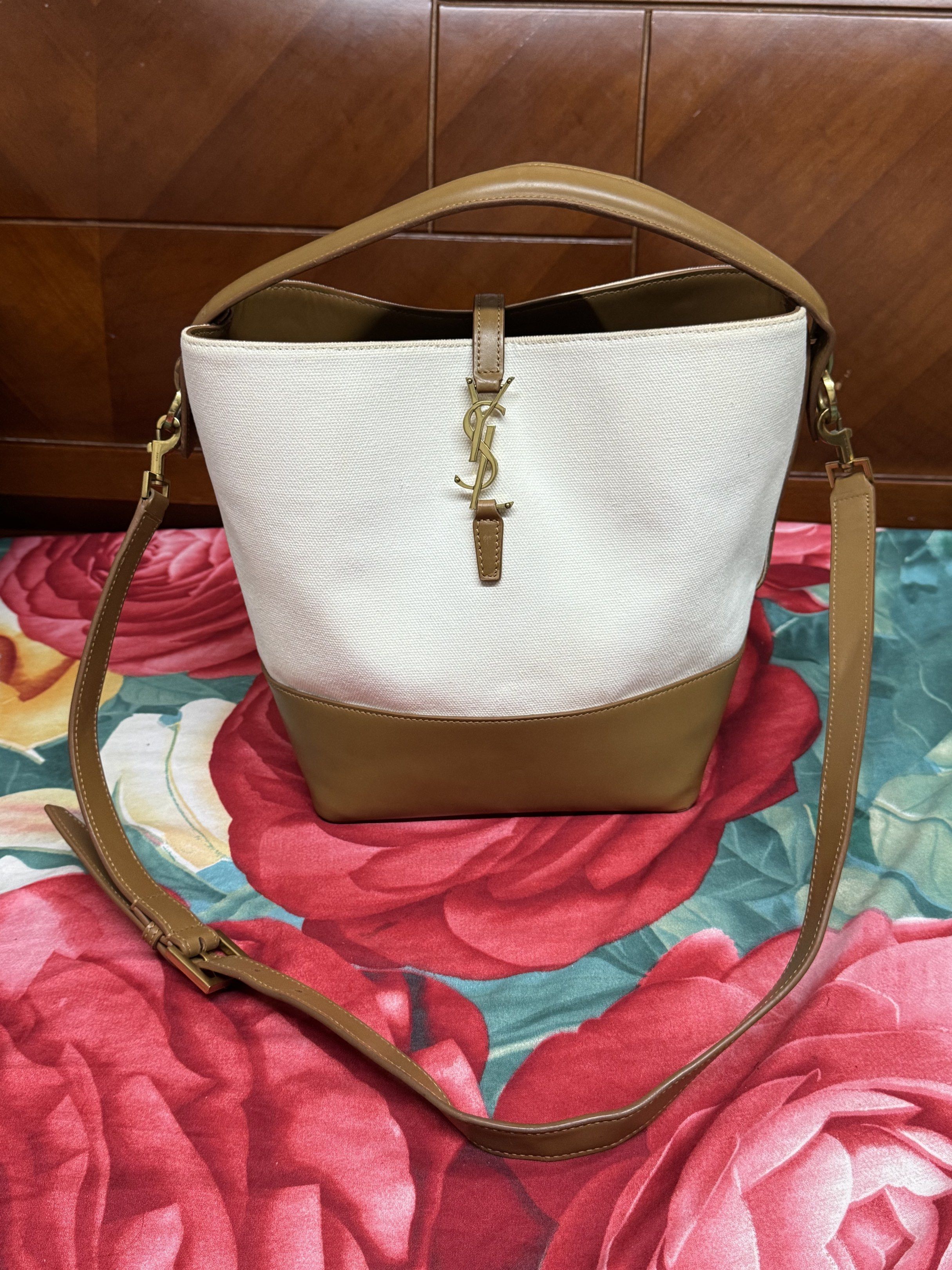 Saint Laurent Canvas Bucket Bag (Category: Luxury Bags & Wallets) located in Quezon City. Submitted by mayang061023 (Listing ID 1423194173, Image 1). Description: - Saint Laurent bucket bag - White canvas and brown leather - Detachable shoulder strap - Top handle - Gold-tone logo.