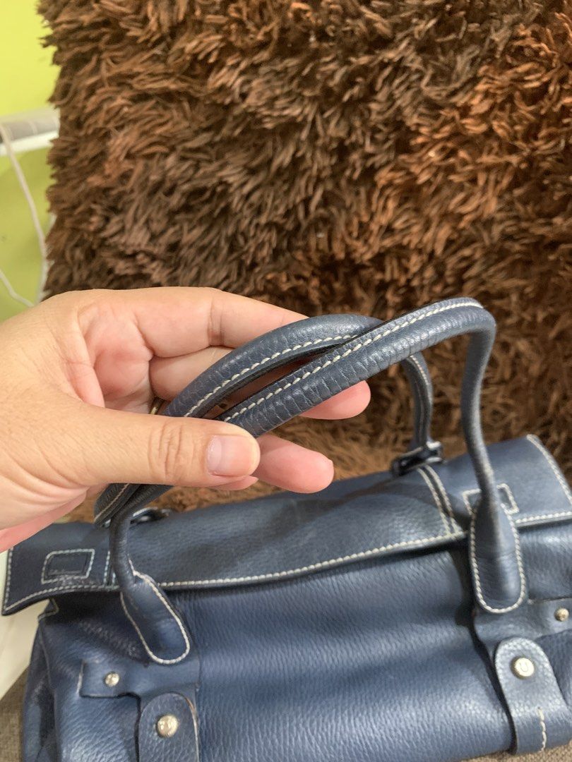 Salvatore Ferragamo Blue Leather Handbag (Category: Luxury Bags & Wallets) located in Liloan. Submitted by jinalyns (Listing ID 1423117265, Image 3). Description: - Salvatore Ferragamo handbag - Elegant blue leather - Structured design - Top handles - White stitching details - Zipper closure - Fabric lining - Branded metal plate - Rectangular shape - High-quality leather.