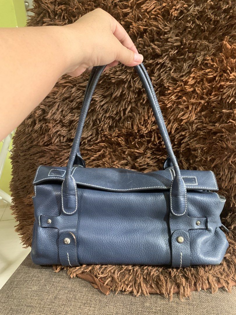 Salvatore Ferragamo Blue Leather Handbag (Category: Luxury Bags & Wallets) located in Liloan. Submitted by jinalyns (Listing ID 1423117265, Image 1). Description: - Salvatore Ferragamo handbag - Elegant blue leather - Structured design - Top handles - White stitching details - Zipper closure - Fabric lining - Branded metal plate - Rectangular shape - High-quality leather.