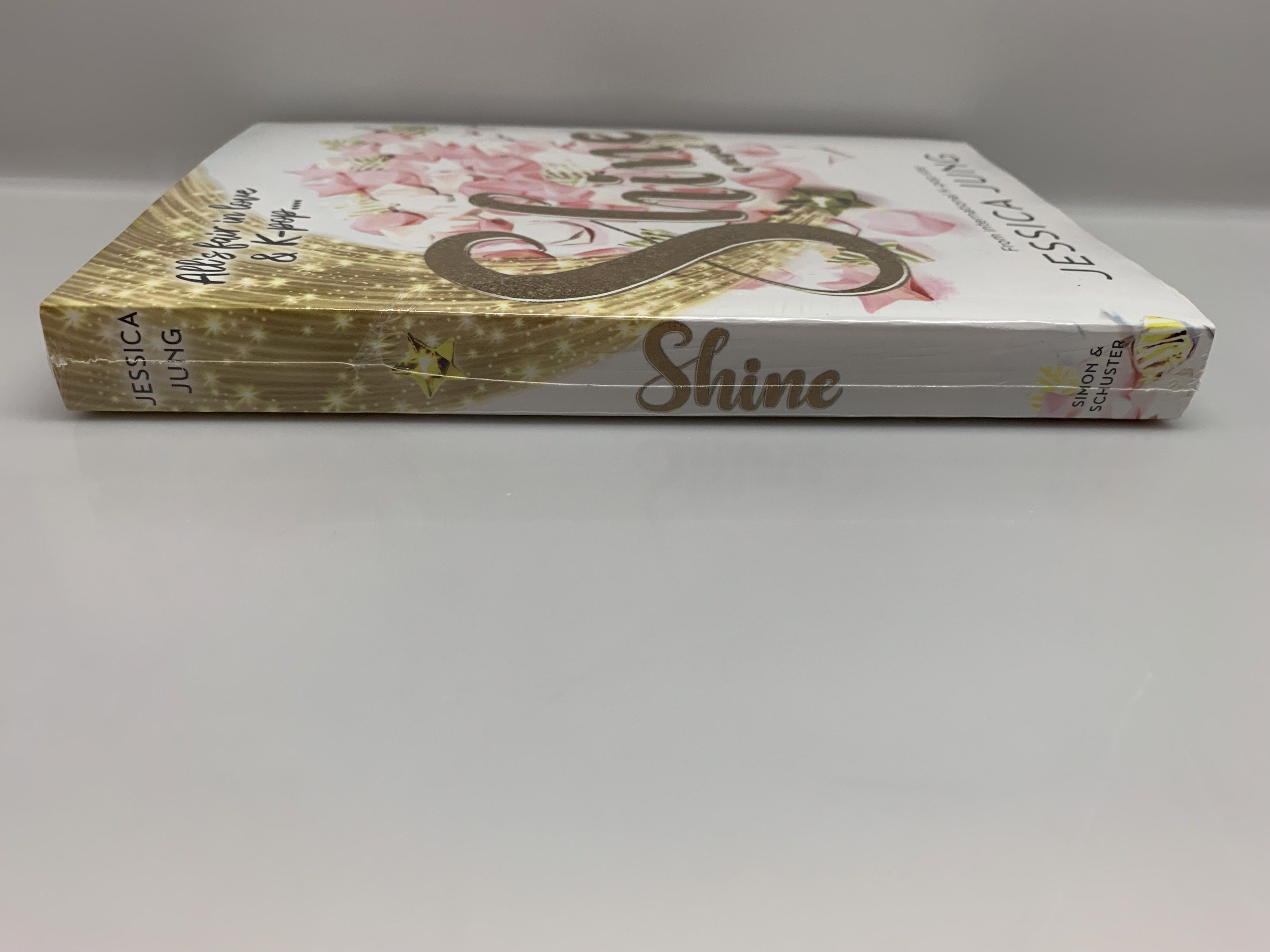 Shine by Jessica Jung (Category: Storybooks) located in Quezon City. Submitted by d.othersetc (Listing ID 1423206892, Image 3). Description: - Brand new, sealed copy of "Shine" by Jessica Jung. - Paperback edition. - Features a gold title font and floral cover design. - Includes a story summary on the back cover. - Still in original packaging..