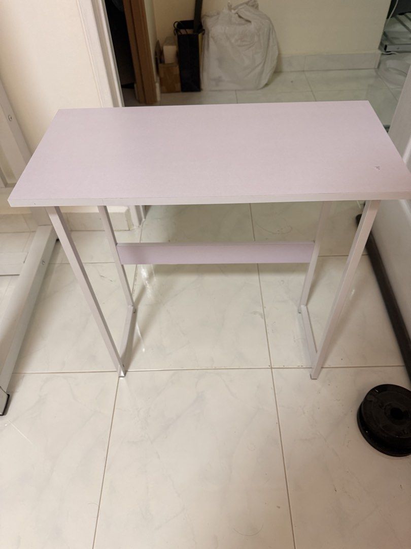 Small study desk (Category: Tables & Sets) located in Singapore. Submitted by mrlooo (Listing ID 1423200039, Image 1). Description: - Suitable for small spaces - White tabletop and metal legs - Minor mark on tabletop - self collect - Dimensions: width: 60cm, depth: 28cm, height: 58cm.