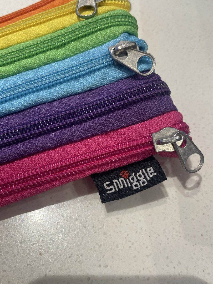 Smiggle Rainbow Multi-Compartment Pencil Case (Category: Stationery & School Supplies) located in Mandaluyong City. Submitted by mclldmrl (Listing ID 1423124810, Image 2). Description: - Smiggle rainbow pencil case - Features multiple zippered compartments - Rectangular shape - Made of colorful fabric - Smiggle logo visible - All zippers intact 2 PCS AVAILABLE.