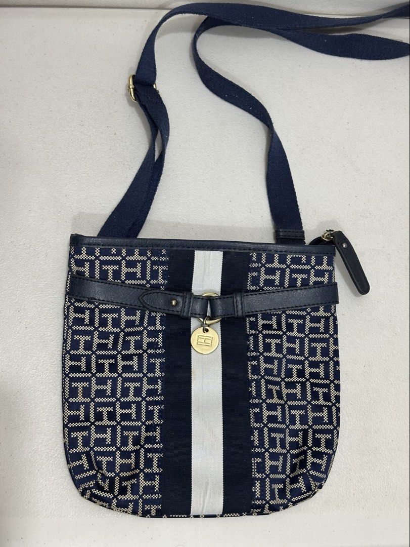 Tommy Hilfiger Crossbody Bag (Category: Cross-body Bags) located in Manila. Submitted by spiceverythingnice (Listing ID 1423172431, Image 1). Description: - Tommy Hilfiger crossbody bag - Color: Navy blue with white stripe - Navy blue strap - Zipper closure - Small interior pocket.