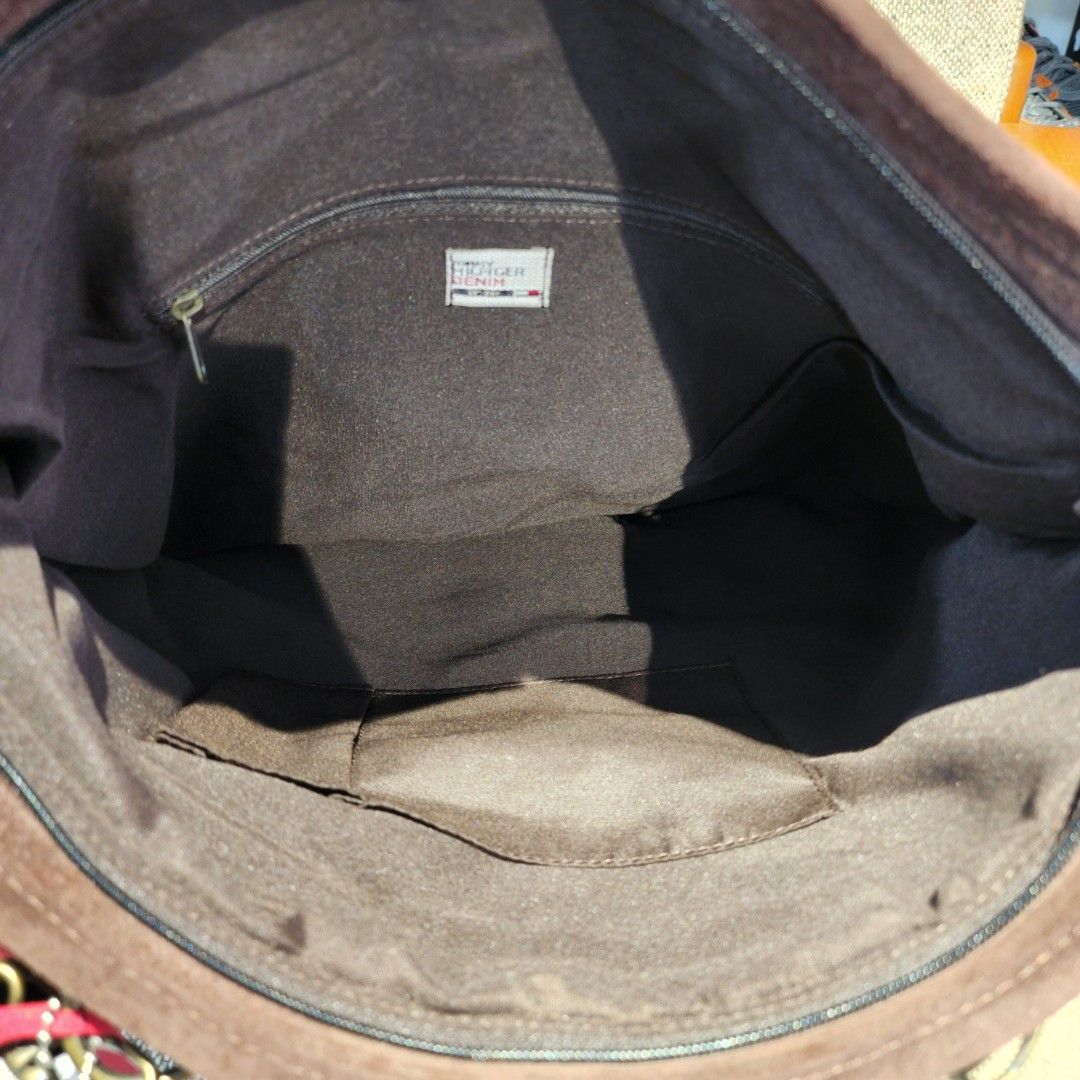 Tommy Hilfiger Denim Suede Handbag (Category: Luxury Bags & Wallets) located in Baguio. Submitted by rjtbootshop2600 (Listing ID 1423199003, Image 3). Description: - Tommy Hilfiger denim handbag - Brown suede material - Front pocket with buckle closure - Main compartment with inner pocket - Shoulder strap and two top handles - Includes brand tag - Dark interior lining.
