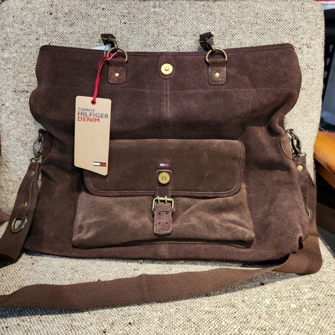 Tommy Hilfiger Denim Suede Handbag (Category: Luxury Bags & Wallets) located in Baguio. Submitted by rjtbootshop2600 (Listing ID 1423199003, Image 2). Description: - Tommy Hilfiger denim handbag - Brown suede material - Front pocket with buckle closure - Main compartment with inner pocket - Shoulder strap and two top handles - Includes brand tag - Dark interior lining.