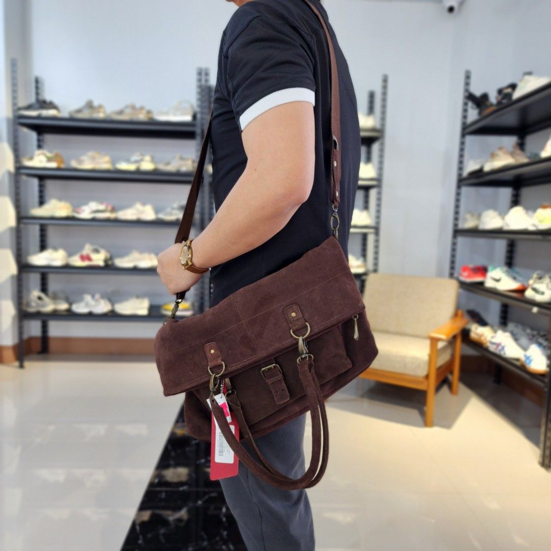 Tommy Hilfiger Denim Suede Handbag (Category: Luxury Bags & Wallets) located in Baguio. Submitted by rjtbootshop2600 (Listing ID 1423199003, Image 1). Description: - Tommy Hilfiger denim handbag - Brown suede material - Front pocket with buckle closure - Main compartment with inner pocket - Shoulder strap and two top handles - Includes brand tag - Dark interior lining.