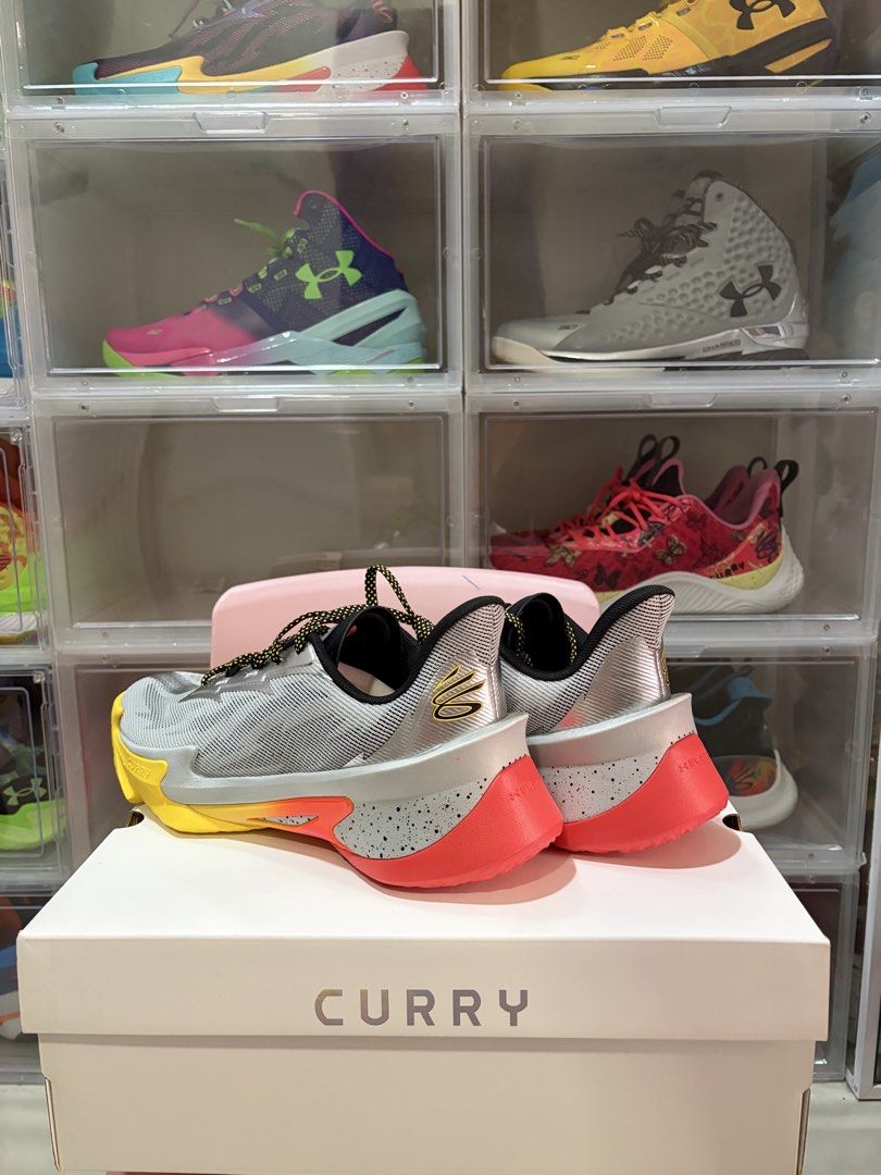 Curry Series 7 “Iron Sharpens Iron” (Category: Sneakers) located in Manila. Submitted by jedmac (Listing ID 1423148313, Image 3). Description: - Under Armour Curry Series 7 - Grey upper with yellow and orange accents - Yellow and red sole - Comes with the original box - Curry logo visible on the heel.