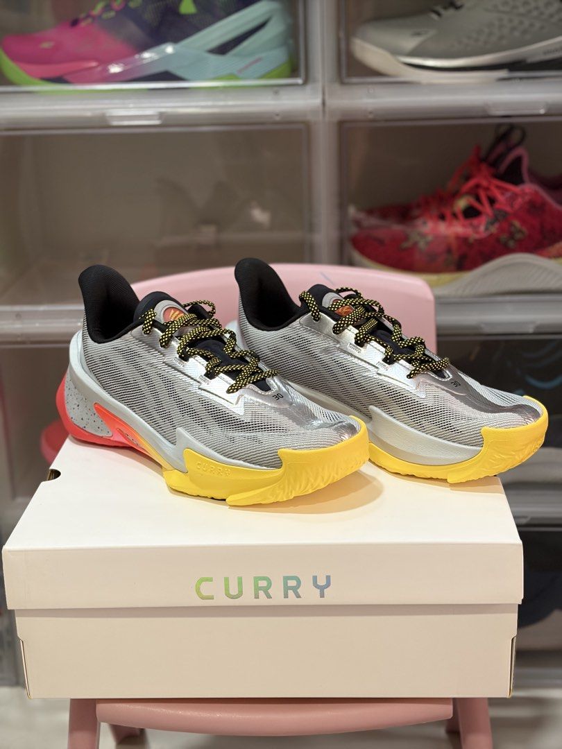 Curry Series 7 “Iron Sharpens Iron” (Category: Sneakers) located in Manila. Submitted by jedmac (Listing ID 1423148313, Image 2). Description: - Under Armour Curry Series 7 - Grey upper with yellow and orange accents - Yellow and red sole - Comes with the original box - Curry logo visible on the heel.