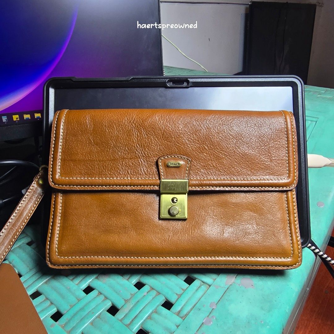 Vintage Bally Brown Leather Clutch (Category: Luxury Bags & Wallets) located in Angeles City. Submitted by haertspreowned (Listing ID 1423234653, Image 1). Description: Authentic Bally leather wallet in brown. Features clasp closure, zippered back, multiple compartments, and wrist strap. Bally logo included. Please chat me for more photos. Open for layaway terms. .