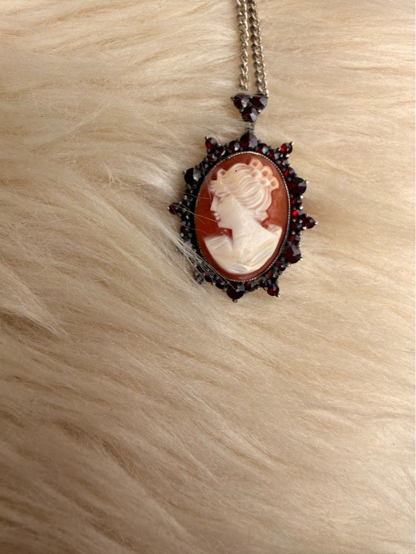Vintage Cameo Pendant Necklace (Category: Necklaces) located in Manila. Submitted by santabhe (Listing ID 1423083029, Image 1). Description: FOR SALE: Mom’s Vintage Cameo Necklace 🐚✨ Price: ₱3,000 Condition: Pre-loved / Well-maintained Elegant and timeless piece from my mom’s personal collection. Perfect for vintage lovers! FEATURES: • Classic Design: Detailed carved silhouette (Cameo). • Accents: Surrounded by deep red stones (Victorian vibe). 