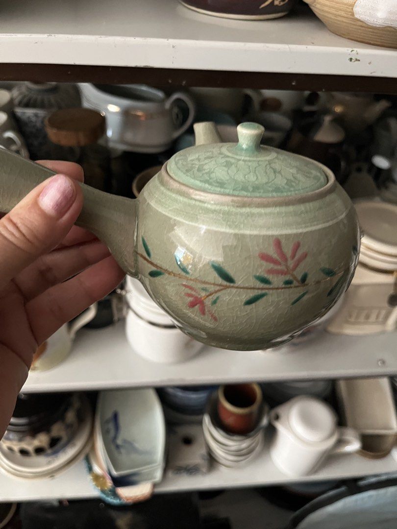 Vintage Ceramic Teapot with Floral Design (Category: Coffee & Tea Tableware) located in Calasiao. Submitted by maxwayne200413 (Listing ID 1423172005, Image 2). Description: - Vintage ceramic teapot - Unique handle design - Floral lid detail - Adorned with pink and green floral patterns - Light green color - Ideal for tea enthusiasts and vintage collectors.