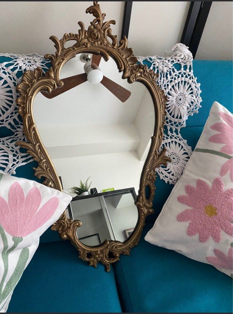 Vintage Ornate Gold Mirror (Category: Mirrors) located in Quezon City. Submitted by waytodeclutter (Listing ID 1423167301, Image 1). Description: - 25 by 15.5 inches - Vintage mirror with an ornate gold frame. - Features a unique and elegant shape. - Ideal for bedroom or living room. - Intricate frame detailing. - Adds vintage charm to any space. .
