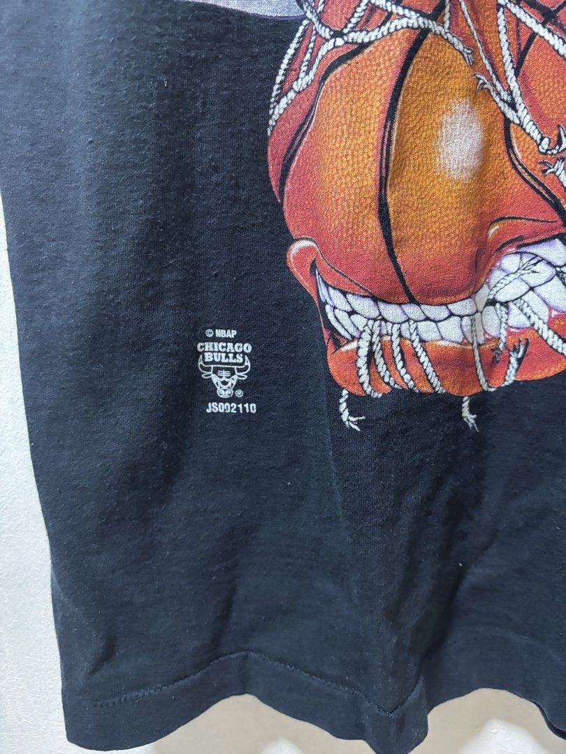 VintageChicago Bulls Tee (Category: Tshirts & Polo Shirts ) located in Calamba. Submitted by bonsaythrift (Listing ID 1423167190, Image 3). Description: - Vintage Chicago Bulls graphic tee - Black color - Features a basketball design - Includes NBA logo - Short sleeves - Crew neck .