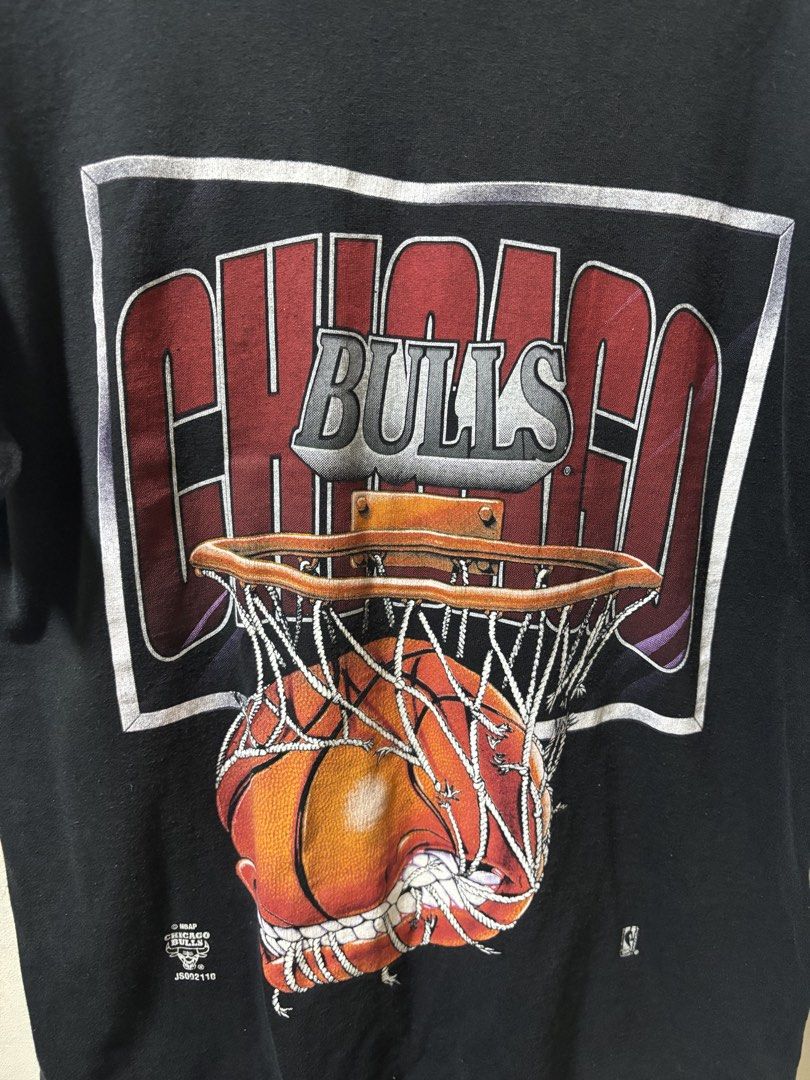 VintageChicago Bulls Tee (Category: Tshirts & Polo Shirts ) located in Calamba. Submitted by bonsaythrift (Listing ID 1423167190, Image 2). Description: - Vintage Chicago Bulls graphic tee - Black color - Features a basketball design - Includes NBA logo - Short sleeves - Crew neck .