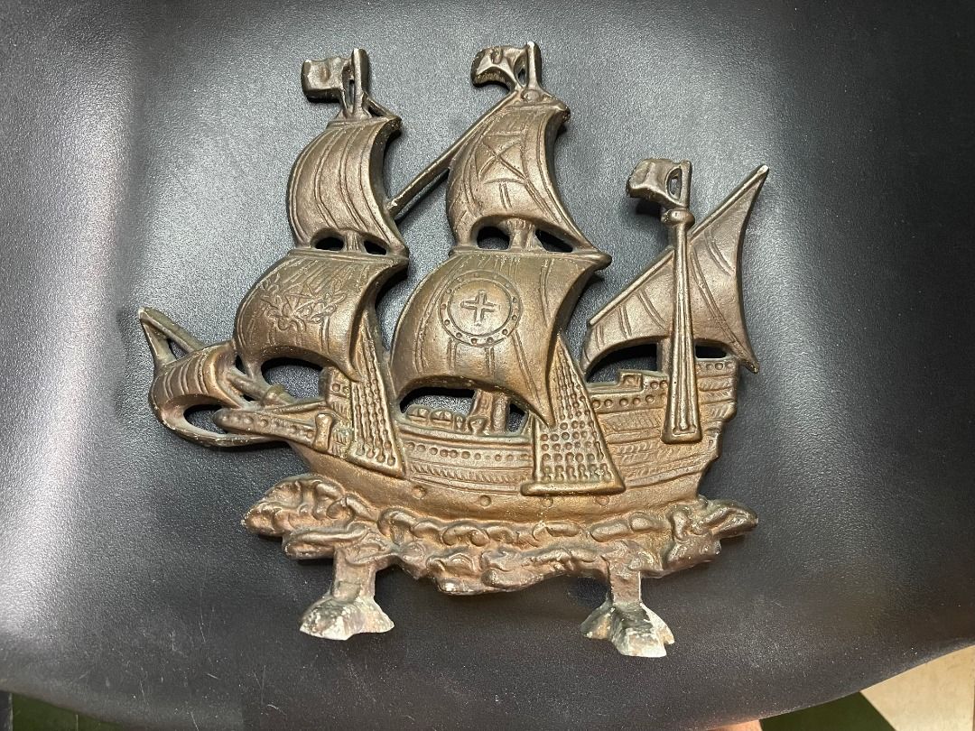 1960s Brass Ship Decor | Vintage (Category: Wall Decor) located in Quezon City. Submitted by reallyrealreal (Listing ID 1423319697, Image 1). Description: Original Price: 5000 Bought in the 1960s Presumably from Thailand See photos for dimensions SKQCET0045 - Vintage metal ship wall decor - Bronze color - Features a ship with three masts and detailed sails - Approximately 12 inches in length - Ideal for nautical-themed rooms or collectors.