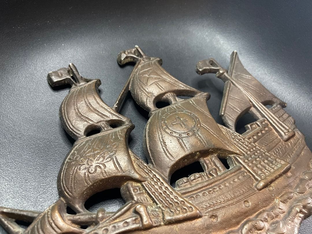 1960s Brass Ship Decor | Vintage (Category: Wall Decor) located in Quezon City. Submitted by reallyrealreal (Listing ID 1423319697, Image 3). Description: Original Price: 5000 Bought in the 1960s Presumably from Thailand See photos for dimensions SKQCET0045 - Vintage metal ship wall decor - Bronze color - Features a ship with three masts and detailed sails - Approximately 12 inches in length - Ideal for nautical-themed rooms or collectors.