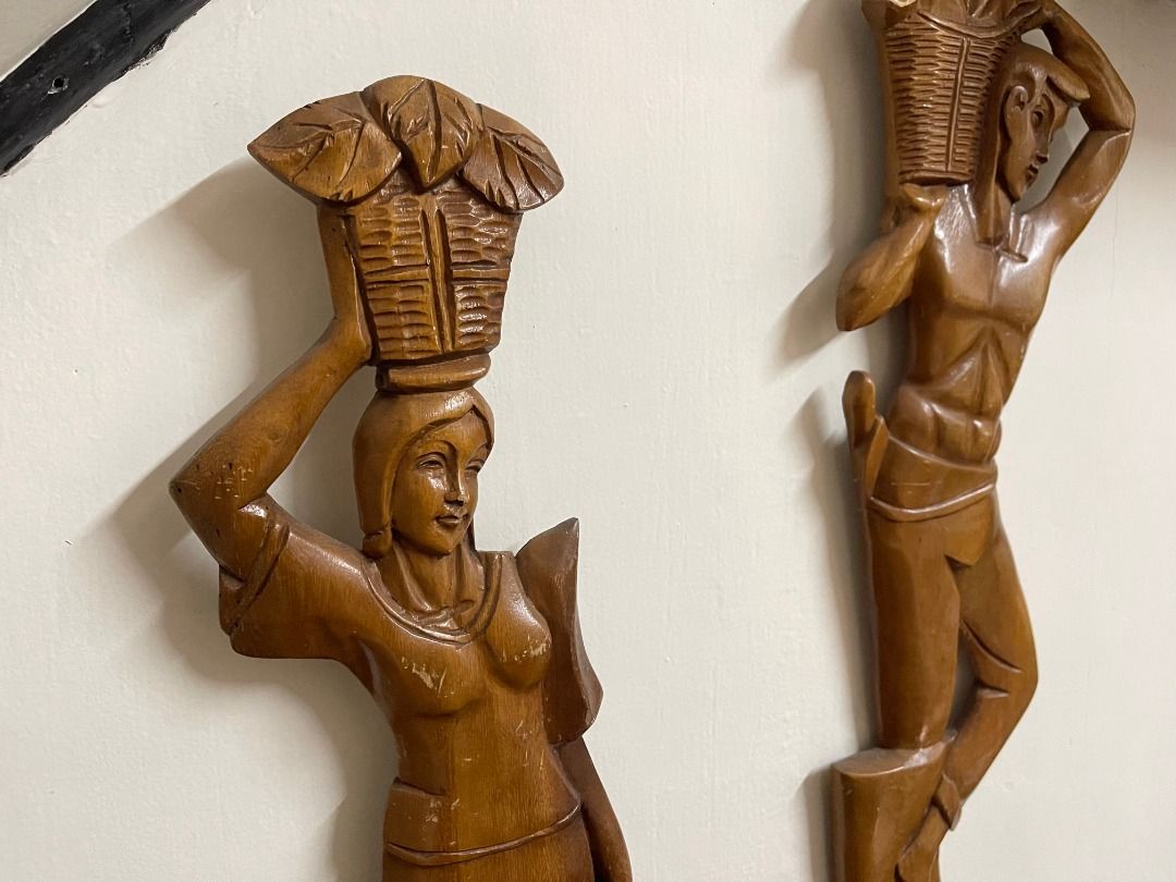 1960s Wooden Decor | Vintage (Category: Wall Decor) located in Quezon City. Submitted by reallyrealreal (Listing ID 1423322534, Image 2). Description: Original Price: 5000 Bought in the 1960s From the Philippines Unknown wood type Per piece Width: 16 Depth: Height: 57 SKQCET0047 - Set of two wooden carved figures - Depicts a man and a woman - Figures are carrying baskets - Hand-carved details - Intended for wall decoration - Brown color - Glossy 