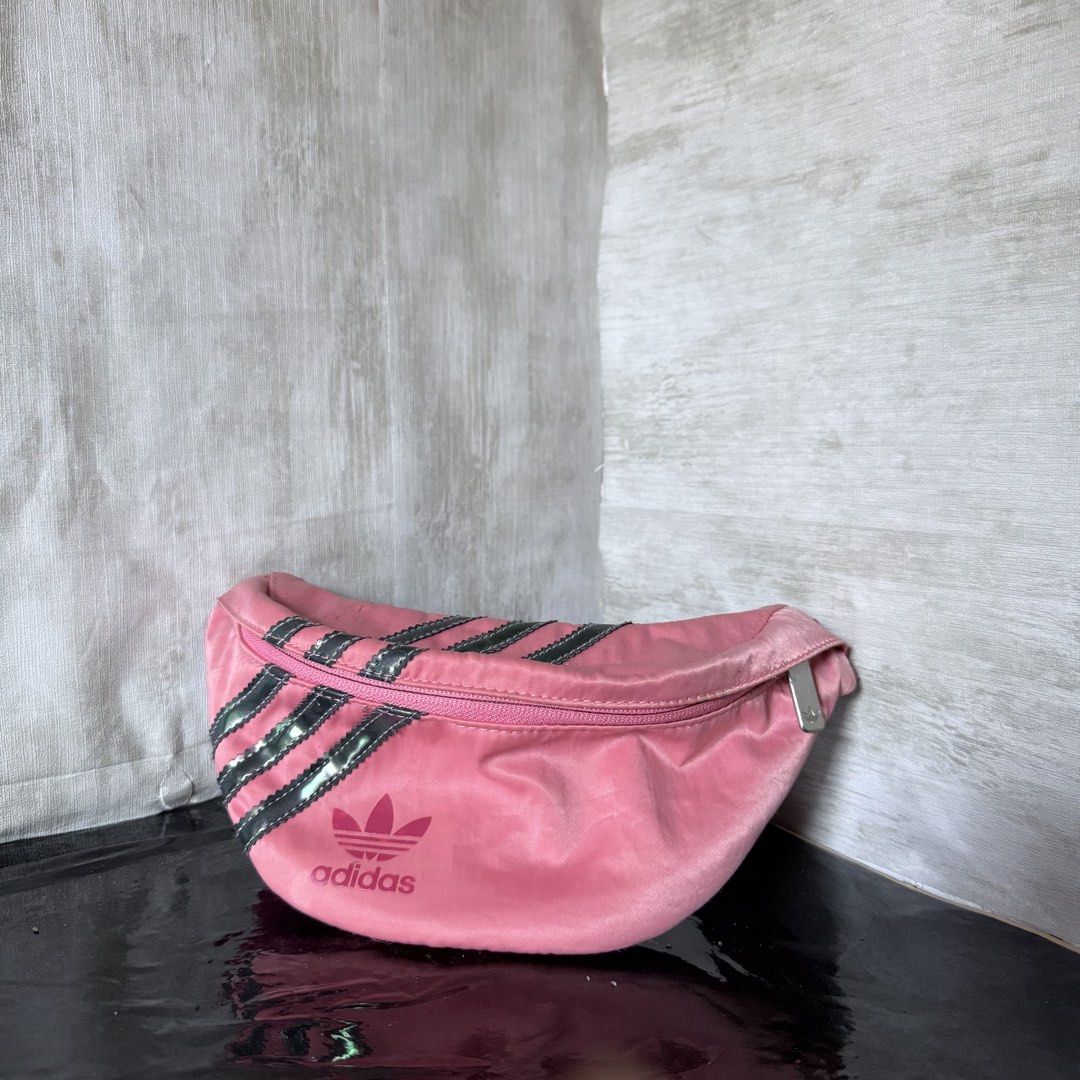 Adidas Pink Waist Bag (Category: Cross-body Bags) located in Dagupan City. Submitted by hangoverph (Listing ID 1423315168, Image 1). Description: - Pink Adidas waist bag - Iconic three stripes design - Main compartment with zipper closure - Adjustable strap - Adidas logo on the front - Lined with matching pink fabric - Ideal for carrying essentials - Used few times - Brand: Adidas - RFS: decluttering.