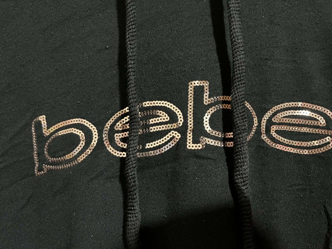 Bebe Sport Hoodie 2X (Category: Coats, Jackets and Outerwear) located in Cebu City. Submitted by lesthrift (Listing ID 1423321975, Image 3). Description: - Bebe Sport hoodie - Size: 2X - Features a sequined brand logo - Drawstring hood - Front pocket - Material: Cotton/Polyester blend - Long sleeves - Comfortable fit.