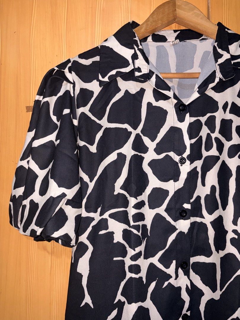 Black and White Print Blouse (Category: Blouses) located in Manila. Submitted by ciiii1 (Listing ID 1423417123, Image 2). Description: - Stylish black and white print blouse. Fits L-XL - Features short, puffy sleeves - Collared neckline - Button-down front - Made from lightweight fabric - Ideal for warm weather - Dress up or down.