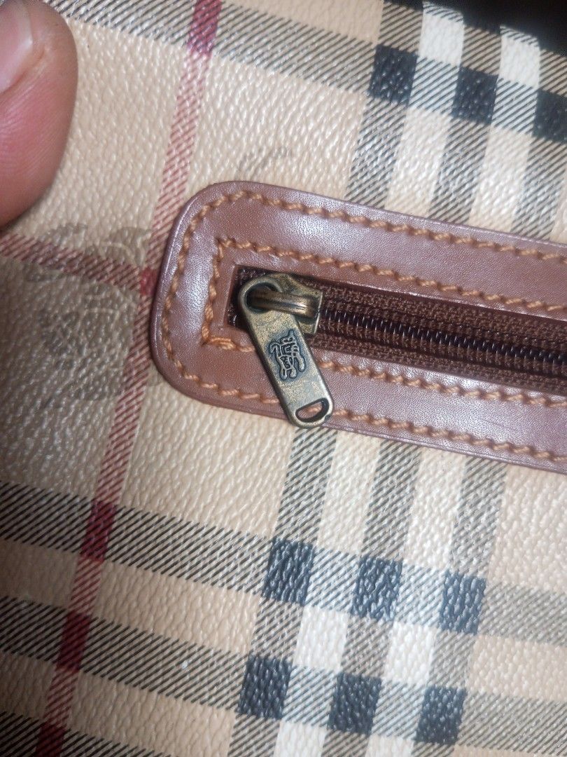 Burberry Crossbody Bag (Category: Luxury Bags & Wallets) located in Davao. Submitted by lordpabito71094 (Listing ID 1423372802, Image 3). Description: - Authentic Burberry crossbody bag - Iconic check pattern - Brown leather strap and trim - Magnetic flap closure - Brown interior lining - Brand logo on zipper - Classic and timeless design.
