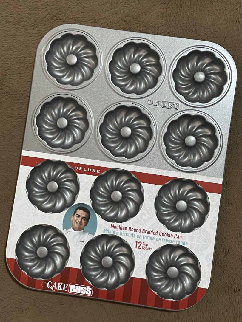 Cake Boss Moulded Round Braided Cookie Pan (Category: Bakeware) located in Paranaque City. Submitted by sachiko.df (Listing ID 1423371823, Image 1). Description: Cake Boss Moulded Round Braided Cookie Pan. It has 12 cup capacity. The pan is designed for baking cookies in a round braided shape. The pan is made of metal and has a non-stick surface. It is perfect for making mini bundt cakes or other small baked goods. The pan is new and unused..