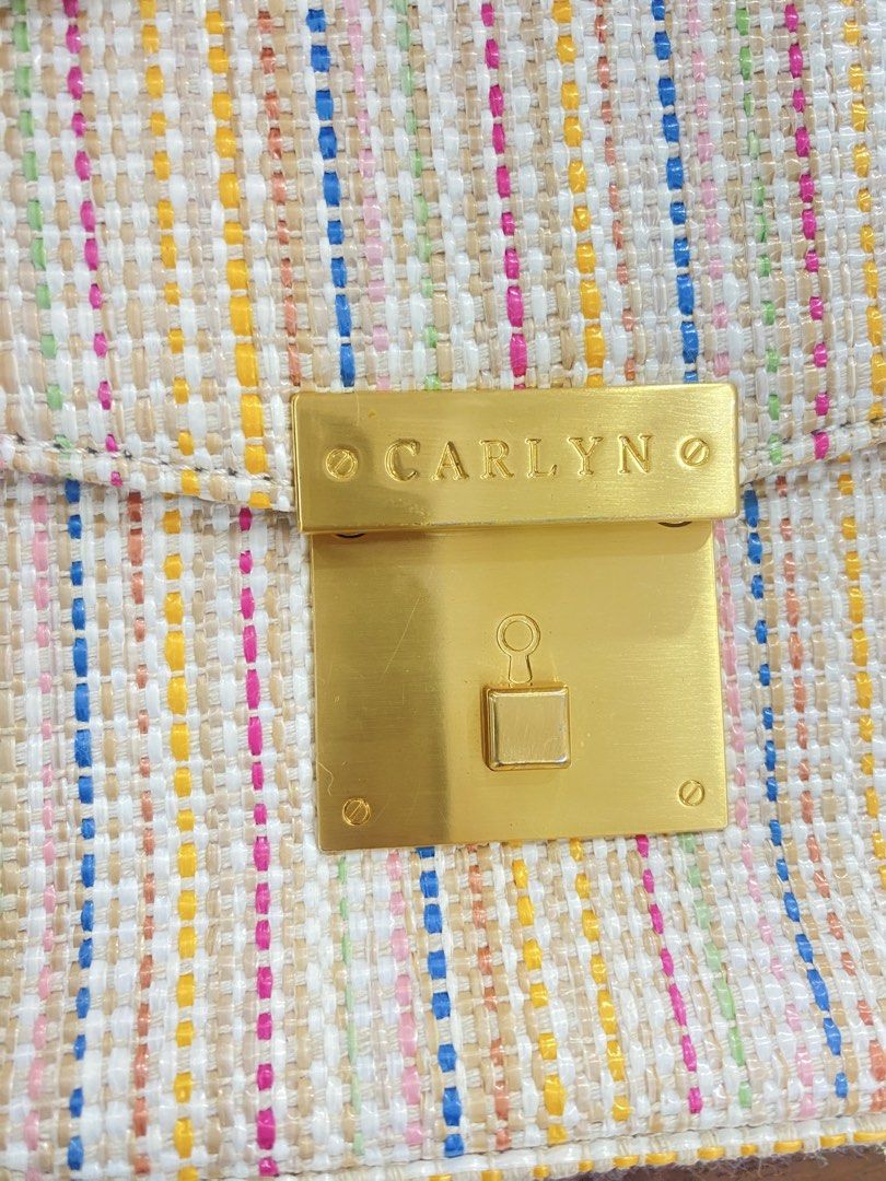 Carlyn Handbag (Category: Luxury Bags & Wallets) located in Guiuan. Submitted by obladi_oblada (Listing ID 1423268201, Image 3). Description: - Brand: CARLYN - Style: Handbag - Exterior: Woven with gold-tone lock closure - Shape: Rectangular - Handle: Top handle - Pattern: Multi-colored stripes - Interior: Lined with light-colored fabric -handbag only no sling strap.