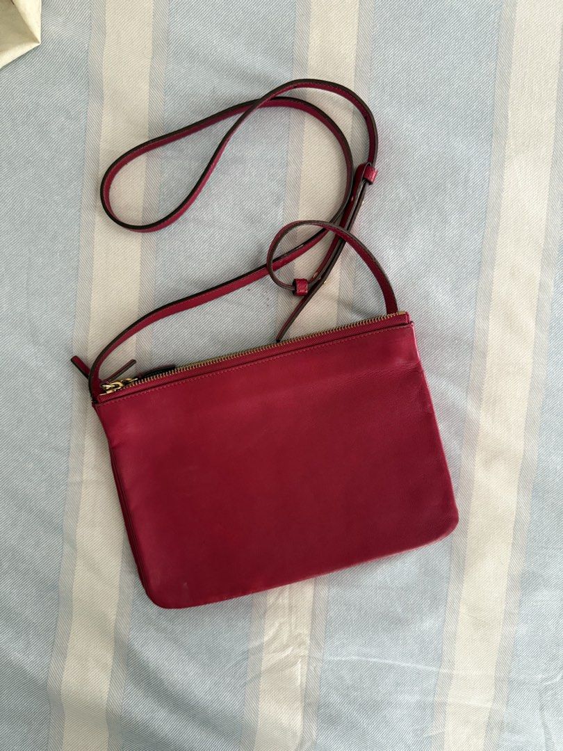 Celine Trio Crossbody Bag (Category: Luxury Bags & Wallets) located in Del Monte. Submitted by mftngc (Listing ID 1423288130, Image 2). Description: - Authentic Celine trio bag - Medium Size - Red leather exterior - Gold zipper - Long, thin strap - Red interior with Celine logo and "Made in Italy" stamp - Celine logo on front .