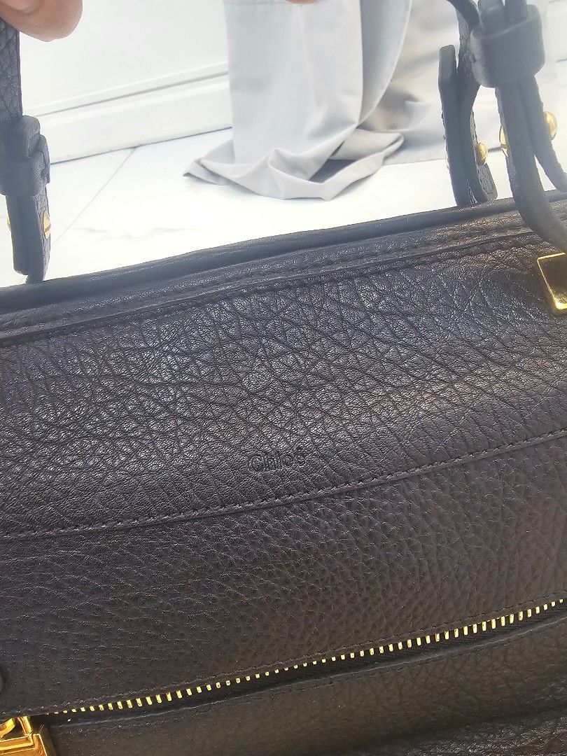 Chloe Black Leather Handbag with Gold Hardware (Category: Luxury Bags & Wallets) located in Las Pinas. Submitted by vanpru (Listing ID 1423325094, Image 2). Description: Chloe top handle bag Very good condition With provided strap - Black leather handbag - Gold-toned hardware - Top handle and detachable shoulder strap - Interior zippered pocket - Brand label - Includes dust bag - Textured leather exterior - Zippered closure.
