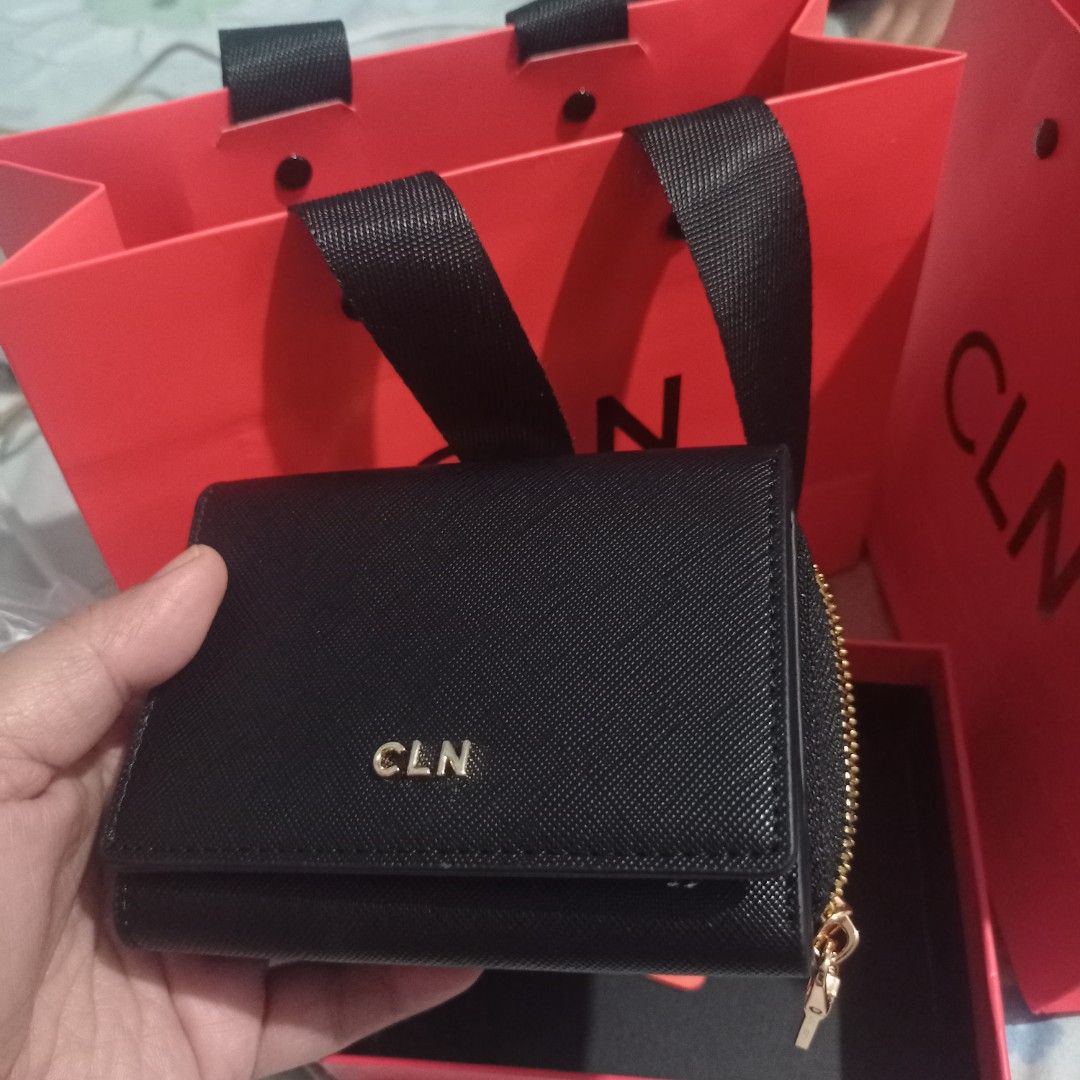 CLN Black Wallet (Category: Wallets & Card holders) located in Manila. Submitted by grandcat-96b481 (Listing ID 1423287570, Image 3). Description: Black CLN wallet with gold-colored zipper and logo. Features multiple compartments for cards and cash. Includes original box and dust bag. Compact and stylish design, perfect for everyday use. The wallet has a snap closure and a coin compartment..
