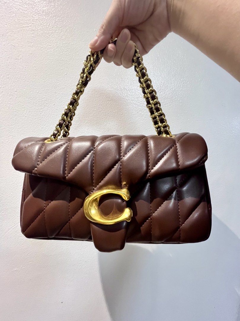 Coach Pillow Quilted Tabby Shoulder Bag 26 (Category: Luxury Bags & Wallets) located in Manila. Submitted by seagypseaph (Listing ID 1423345633, Image 1). Description: 20% OFF! Happening from May 18-25! OG Price: Php6,800 Coach Pillow Tabby Shoulder Bag 26 Rank S-A (Brand new-like new condition; Not guaranteed auth) - Pillow Quilted design - Rich maple brown color (rare color) - Gold Chain strap (adjustable/worn 2 ways) - Flap closure with gold-t