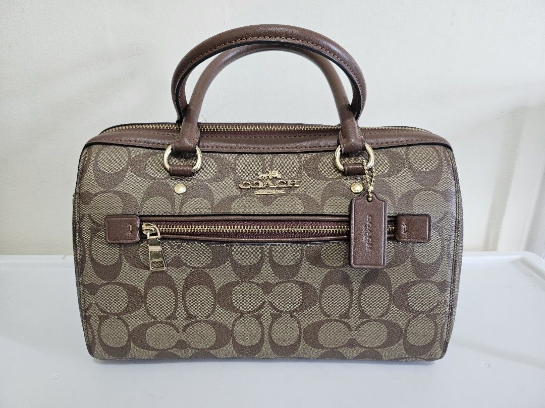 Coach Rowan in Signature Canvass (Category: Luxury Bags & Wallets) located in Quezon City. Submitted by sheyguzman (Listing ID 1423333559, Image 1). Description: Rowan Satchel - Color Sig Brown - 10 1/2" (L) x 6 1/4" (H) x 5 1/2" (W) - Signature coated canvas fabric lining - Exterior Front Zip Pocket - Top Zip Closure - Detachable, Adjustable Long Strap for Shoulder or Crossbody Wear - 1 Inside Zip Pocket and multifunction pockets.