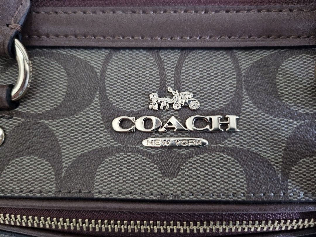 Coach Rowan in Signature Canvass (Category: Luxury Bags & Wallets) located in Quezon City. Submitted by sheyguzman (Listing ID 1423333559, Image 2). Description: Rowan Satchel - Color Sig Brown - 10 1/2" (L) x 6 1/4" (H) x 5 1/2" (W) - Signature coated canvas fabric lining - Exterior Front Zip Pocket - Top Zip Closure - Detachable, Adjustable Long Strap for Shoulder or Crossbody Wear - 1 Inside Zip Pocket and multifunction pockets.